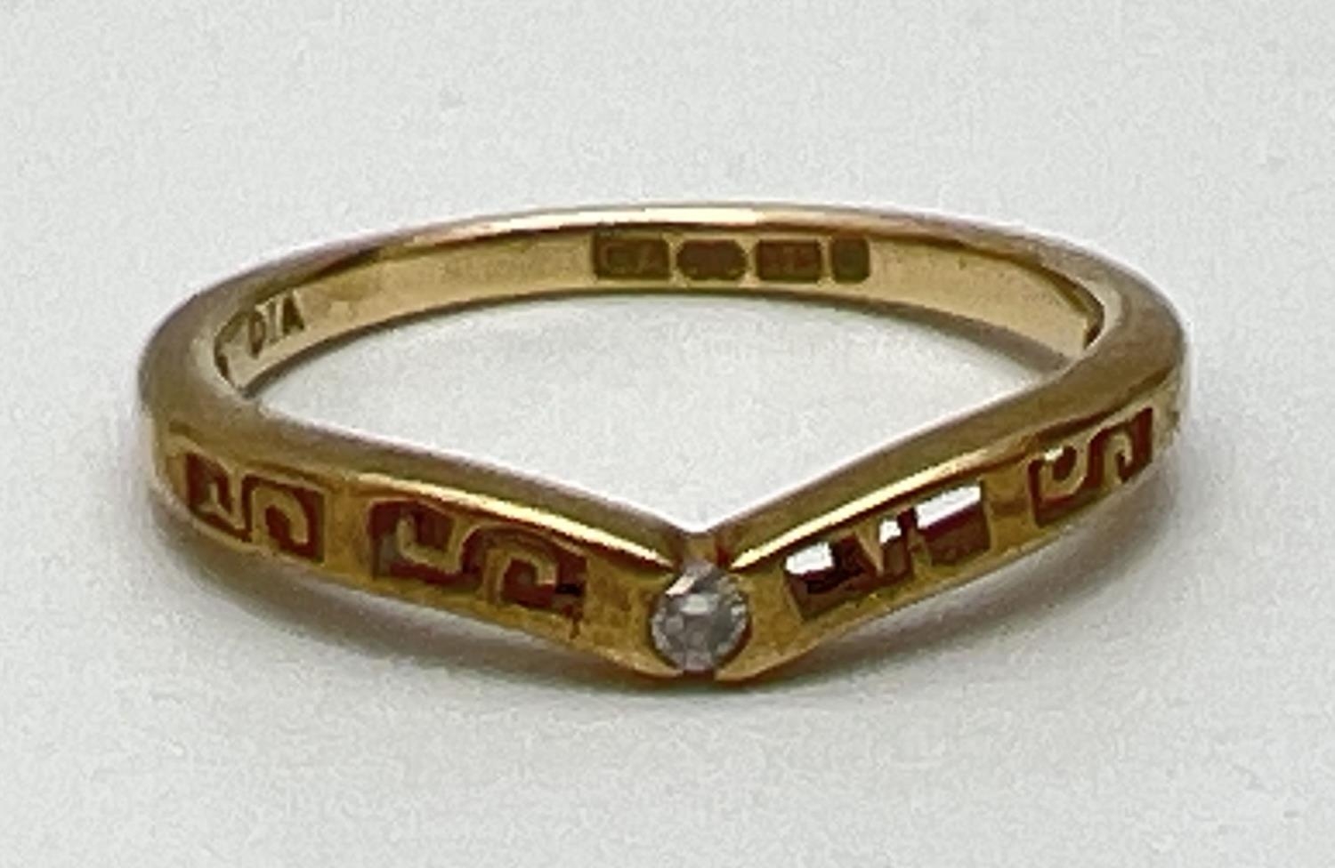A 9ct yellow gold wishbone ring set with central diamond and with pierced work detail. Fully