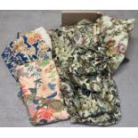 A box of vintage curtains and material in floral designs.