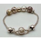 A boxed Thomas Sabo silver charm bracelet with a collection of varying design charm beads. To