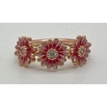 A 14ct rose gold plate and enamel finish 3 pink daisy dress ring by Pandora. Inside of band marked