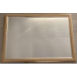 A large modern wall hanging mirror with bevel edged glass and gilt detail to frame. Frame size