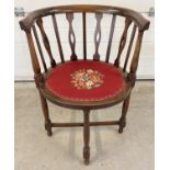 An Edwardian Captains chair with inlaid detail, shaped spindle and curved back. Crossover strut
