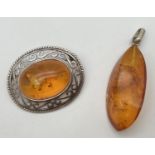 2 pieces of amber jewellery. A piece of amber in a drop style pendant together with a white metal