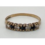 A 9ct yellow gold, sapphire & clear stone half eternity ring. Fully hallmarked inside band. Ring