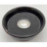 A small antique ebony wood pin bowl with central round silver cartouche with floral engraved