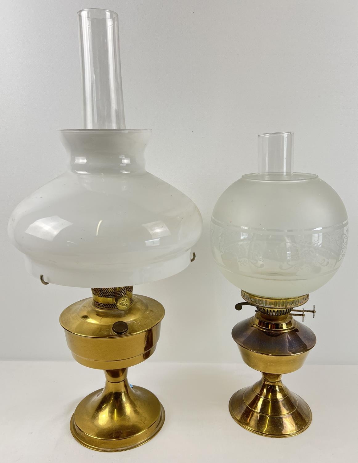 2 vintage brass based oil lamps with glass shades and chimneys. Largest approx. 60cm tall (with