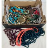 A box of vintage and modern costume jewellery. To include faux pearl statement necklace, rings and