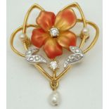 A Joan Rivers gold tone brooch with floral detail and freshwater pearl hanging pendant. Set with