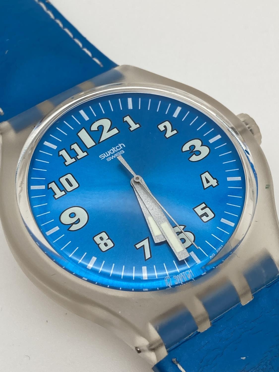 A unisex S216 Swatch watch with metallic blue face and original blue leather strap. Luminescent - Image 2 of 4