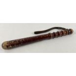 A vintage wooden truncheon with ribbed handle and leather thong. Approx. 40cm long.