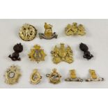 A collection of assorted vintage and modern military cap badges. To include: Royal Artillery,