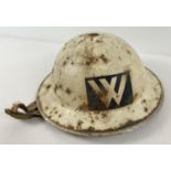 A British WWII Home Front MkII helmet painted white for night time use. With unusual Warden (W)