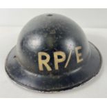 A WWII British Home Front MkII steel helmet, painted black with letters RP/E. For Repair Party/