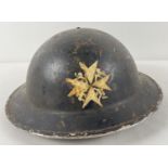 A WWII British Home Front MkII No.2C steel helmet with early oval pad. Painted black with St. John