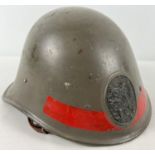 A WWII Dutch M23-27 steel helmet complete with liner and chinstrap. Badge on front bearing Dutch