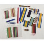 A vintage Ardath tobacco tin containing assorted medal ribbons.