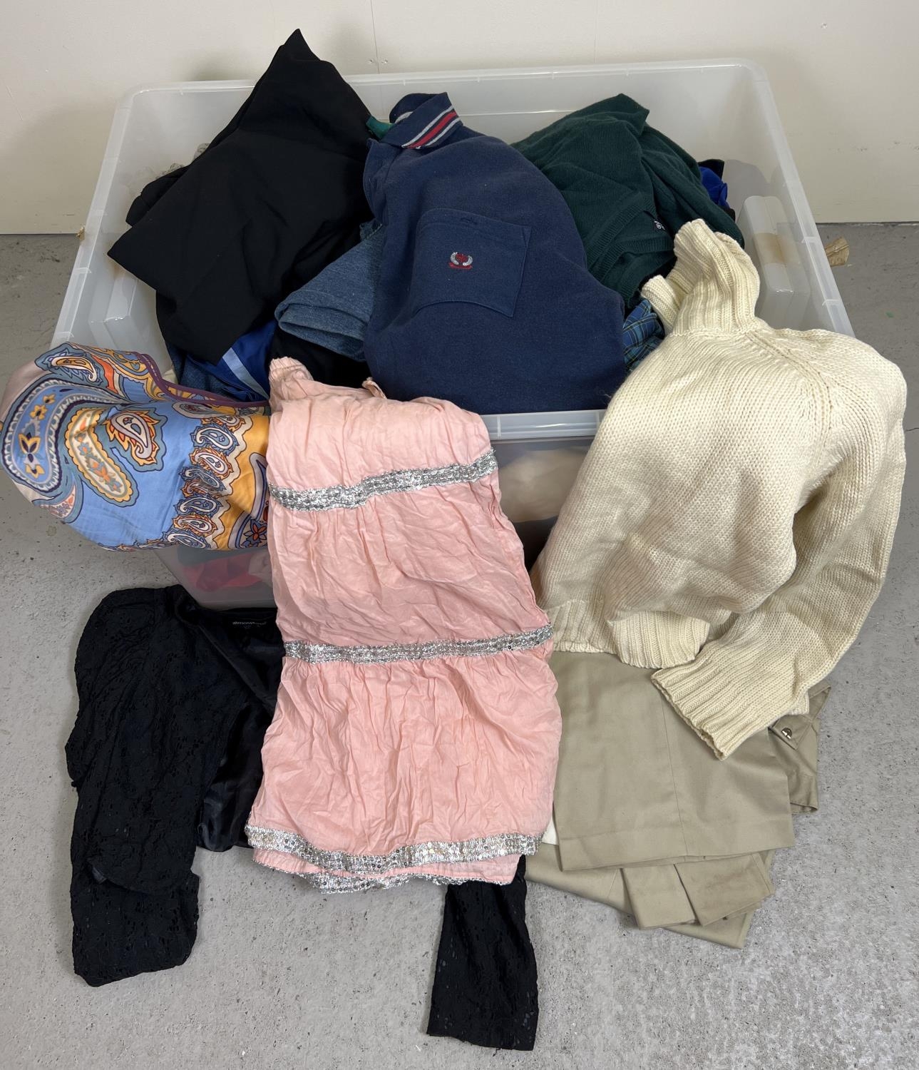 A large box of assorted ladies & men's clothing, to include skirts, trousers, tops and jumpers.