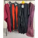 4 vintage graduation gowns and academic hoods. In varying colours.