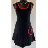 A 1970's black sleeveless jersey mini dress with red piping detail and cherries applique. By Chelsea