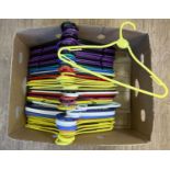 A box of 50 assorted coloured plastic coat hangers.