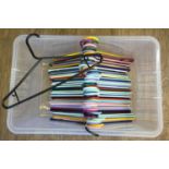 A box of 50 coloured plastic coat hangers of the same design.