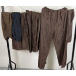 9 pairs of theatre costume trousers and pantaloons in brown and black.