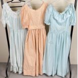 3 vintage 1980's full length, short sleeved dresses/ball gowns, in shades of pale green and peach.