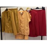 3 ladies skirt suits. A mustard long sleeve jacket suit, a yellow short sleeve jacket suit and a