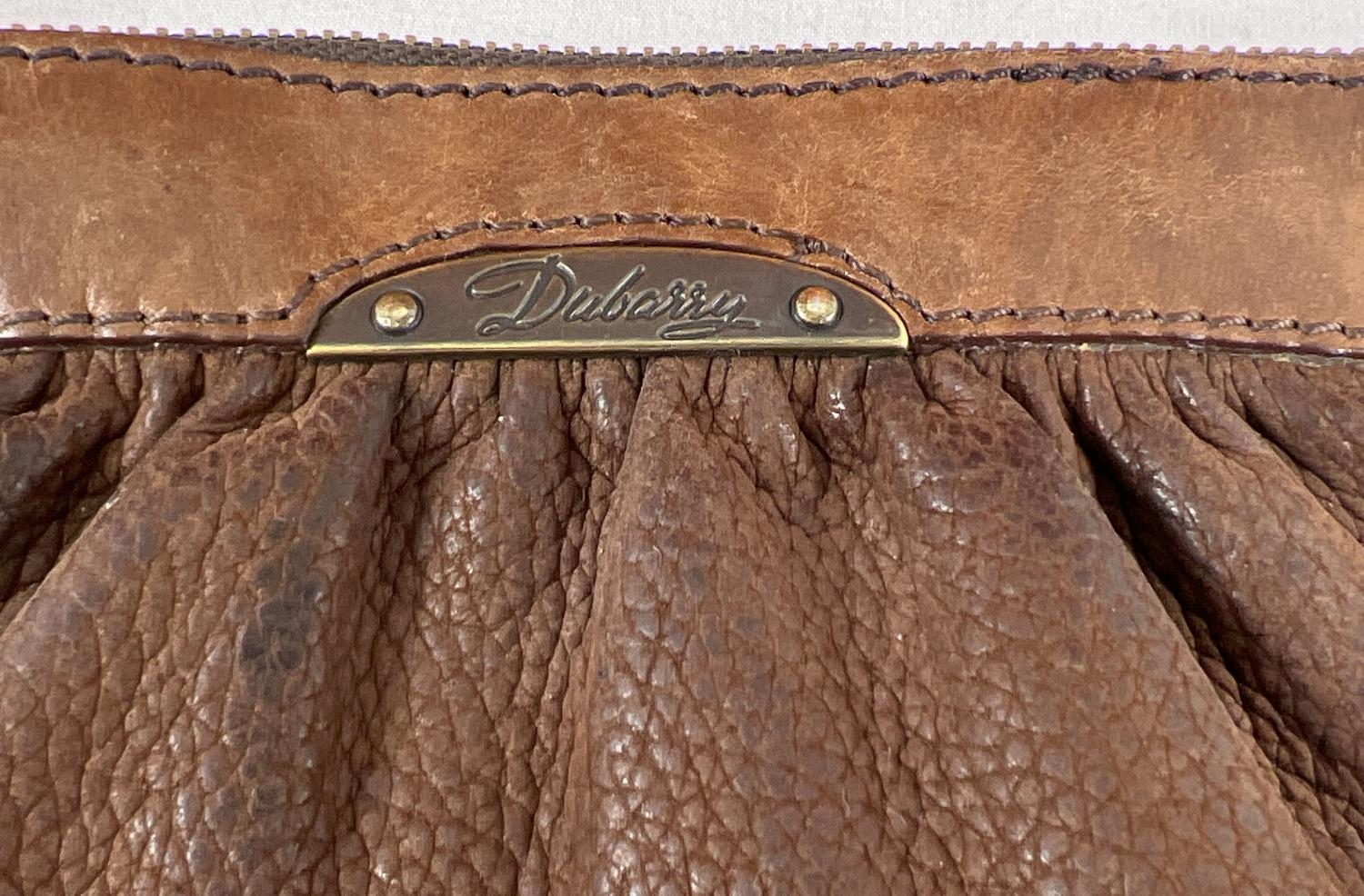 A brown leather wristlet clutch purse by Dubarry, Ireland together with a large orange faux - Image 2 of 3
