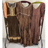 3 vintage theatre costume Georgian style long sleeved dresses. In brown tones.