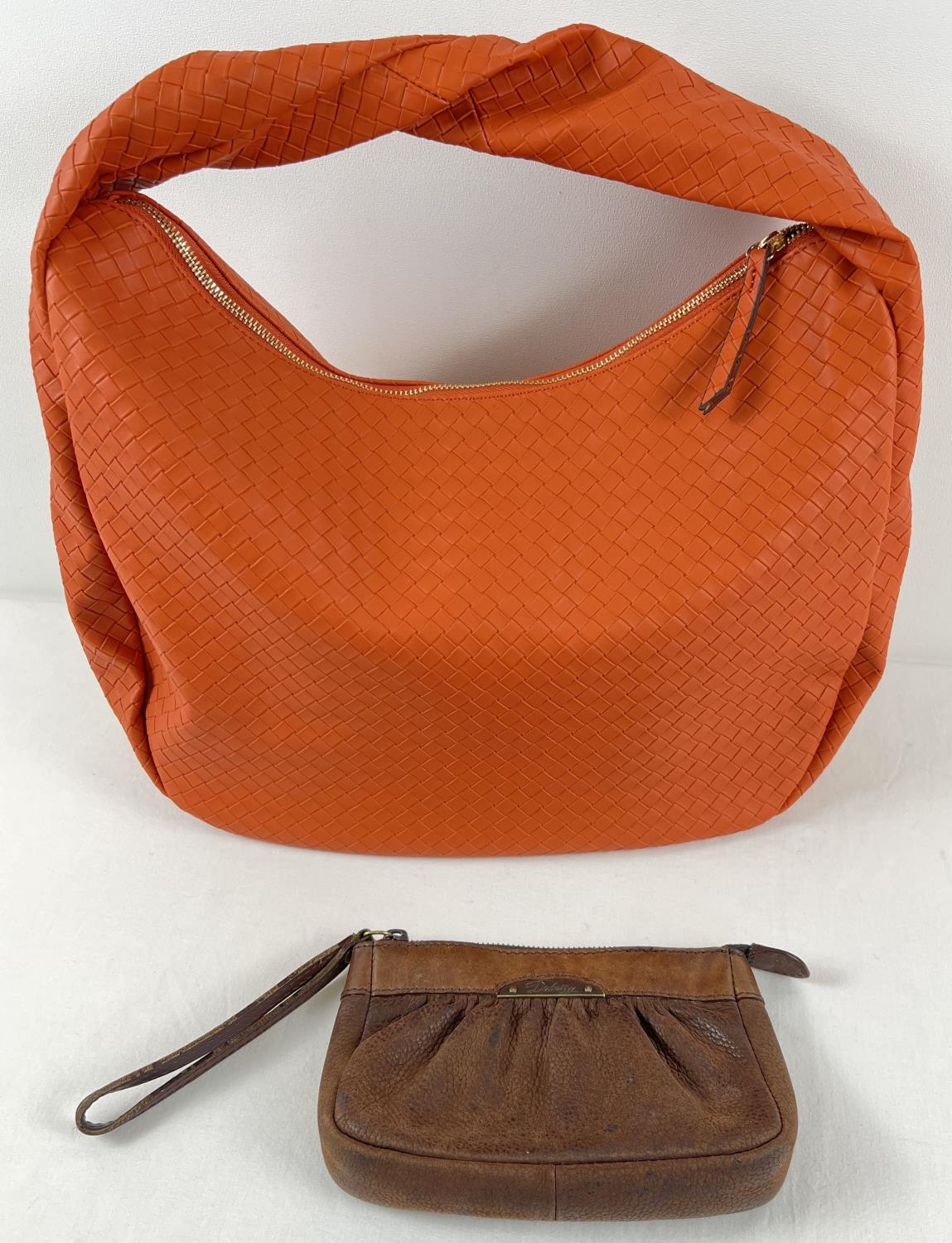 A brown leather wristlet clutch purse by Dubarry, Ireland together with a large orange faux