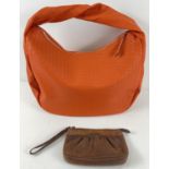 A brown leather wristlet clutch purse by Dubarry, Ireland together with a large orange faux