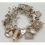 A vintage double curb chain silver charm bracelet with padlock clasp and safety chain. Complete with