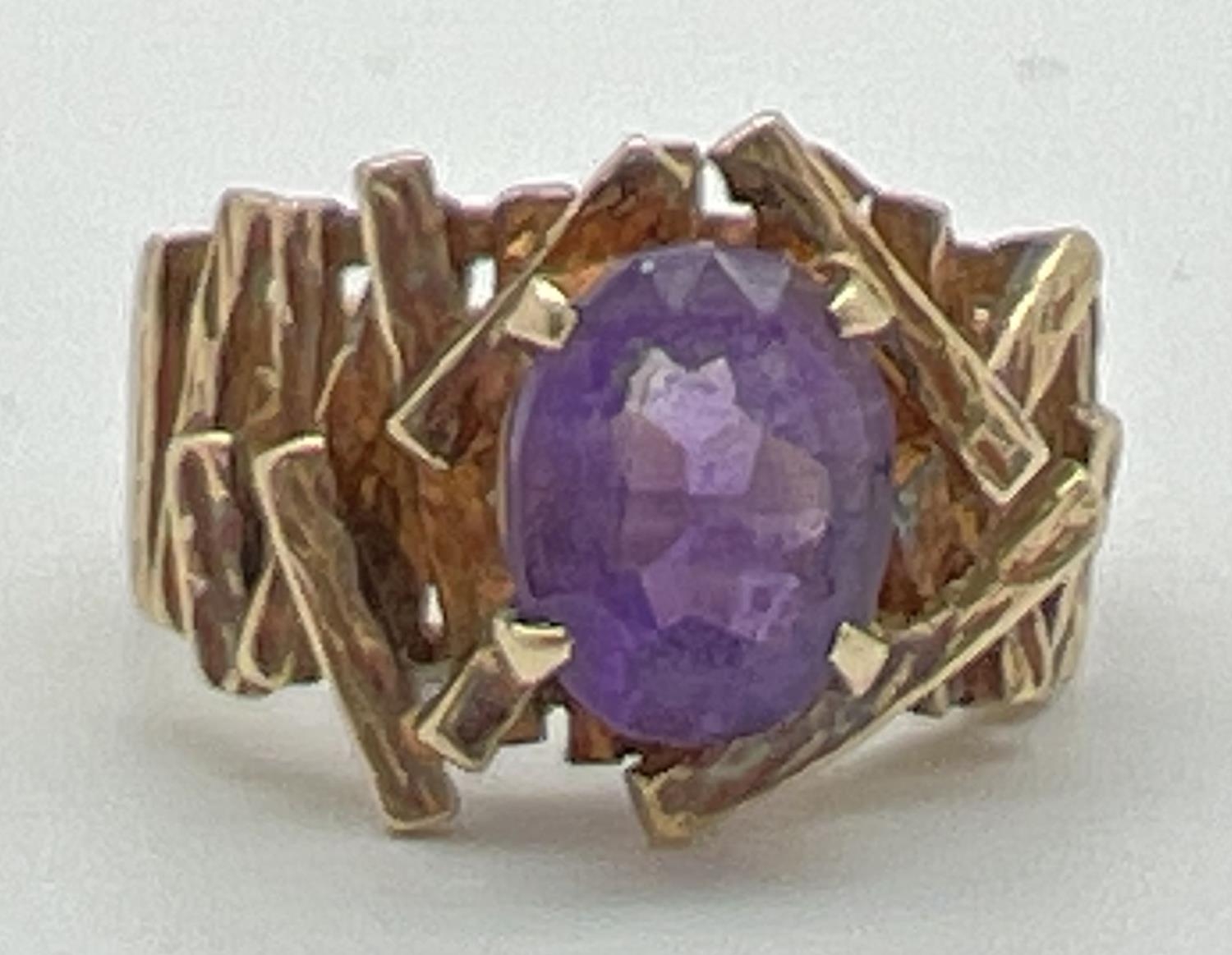 A chunky vintage 9ct yellow gold dress ring set with central oval cut amethyst. With textured