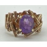 A chunky vintage 9ct yellow gold dress ring set with central oval cut amethyst. With textured