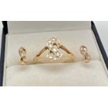 A 14ct yellow gold ring set with 8 diamonds in the shape of the letter 'S'. Together with a pair