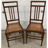 A pair of Arts & Crafts design bedroom chairs with inlaid detail, front tapered legs and re-caned