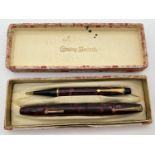 A 1950's Conway Stewart marbled burgundy pen and propelling pencil set. Comprising #14 fountain