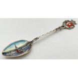 A Turkish 800 silver collectors spoon with enamelled Turkish flag and crown detail finial. Twist