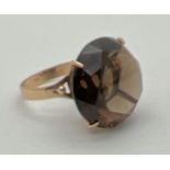 A vintage 9ct gold large smoked quartz cocktail ring. Worn hallmarks to inside of band. Tests as 9ct