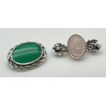 2 decorative silver and natural stone set brooches. An oval shaped brooch with twist design mount