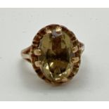A vintage 9ct gold dress ring set with a large oval cut green citrine stone. High shoulder with a
