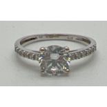 A 9ct white gold dress ring set with cubic zirconia stones. Central round cut stone with 6 small