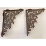 A pair of rust effect cast metal wall shelf bracelets, with decorative scroll & leaf design. Approx.