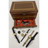 A wooden jewellery box with inlaid detail to lid and body containing a small collection of