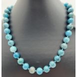 An 18" Paraiba Apatite round bead knotted necklace with white metal magnetic clasp.