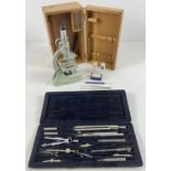 A wooden boxed microscope by Regent together with a cased scientific instrument set. Microscope