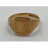 A men's vintage 9ct gold signet ring with ribbed detail to shoulders and empty square cartouche.