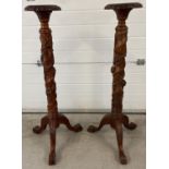 A pair of mahogany 3 footed torcheres with carved detail. Twisted pedestal stems with grape & vine