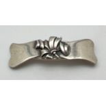 A vintage sterling silver hair clip with central embossed floral design. Stamped 'sterling' to